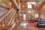 Arrow Lodge-Living room and log stair case. 